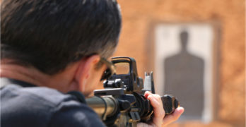 Police firearms training with AR-15 at shooting range.
