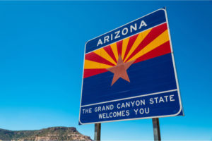 Arizona state border highway sign with a sky blue background