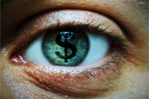 Closeup image of a man with a dollar symbol in his eye