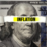 Torn bills revealing Inflation words. Idea for FED consider interest rate hike, world economics and inflation control, US dollar inflation